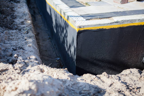 Professional Waterproofing technician working in Howell, MI